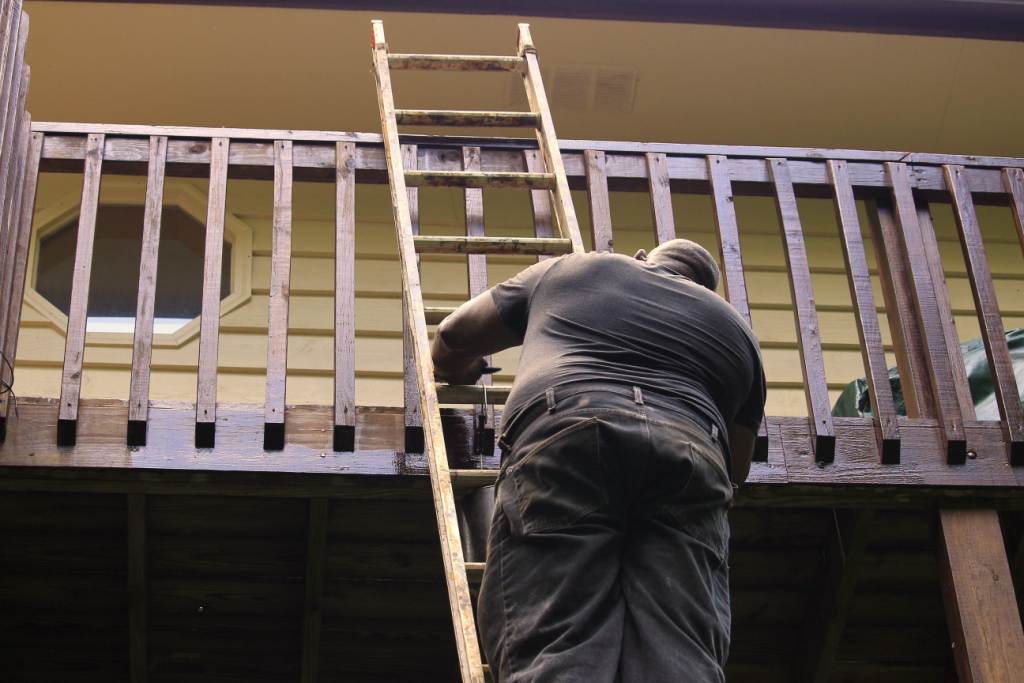 Worker Paint the Wooden Railing