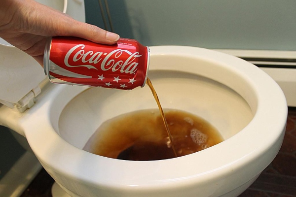 Cleaning toilet WC with Coke
