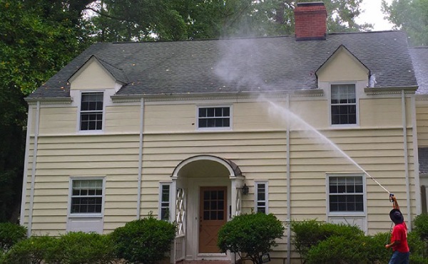 Pressure washing the exterior of house
