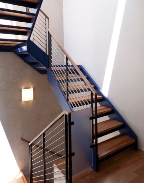 Metal stair with a combination of wooden step and handrail