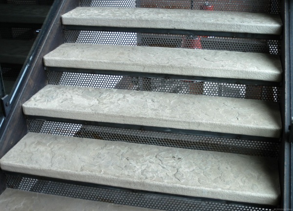 Metal stair with the stone slab as a tread