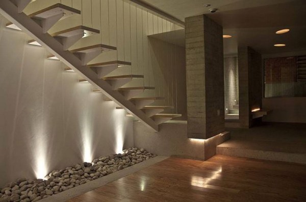 Modern Cantilevered or Floating Open Straight Internal Staircase with a supporting Beam below it & Ropes as railings up to the ceiling highlighted by Spot Lights from below.